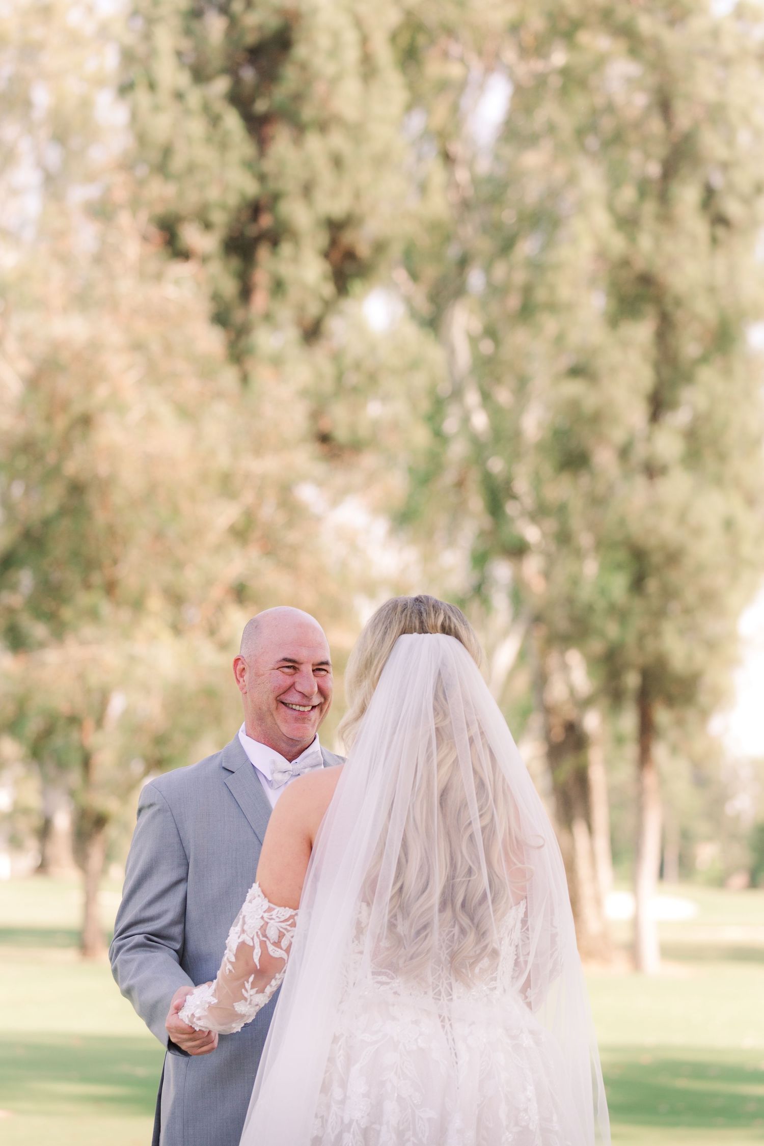 Emotional first look moment between couple during outdoor wedding ceremony.