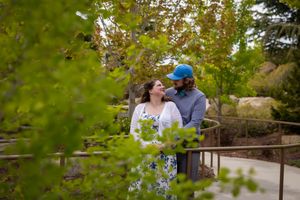 couple looking at each other surrounded by lush greenery
