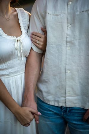 focus on engagement ring holding groom to be arm