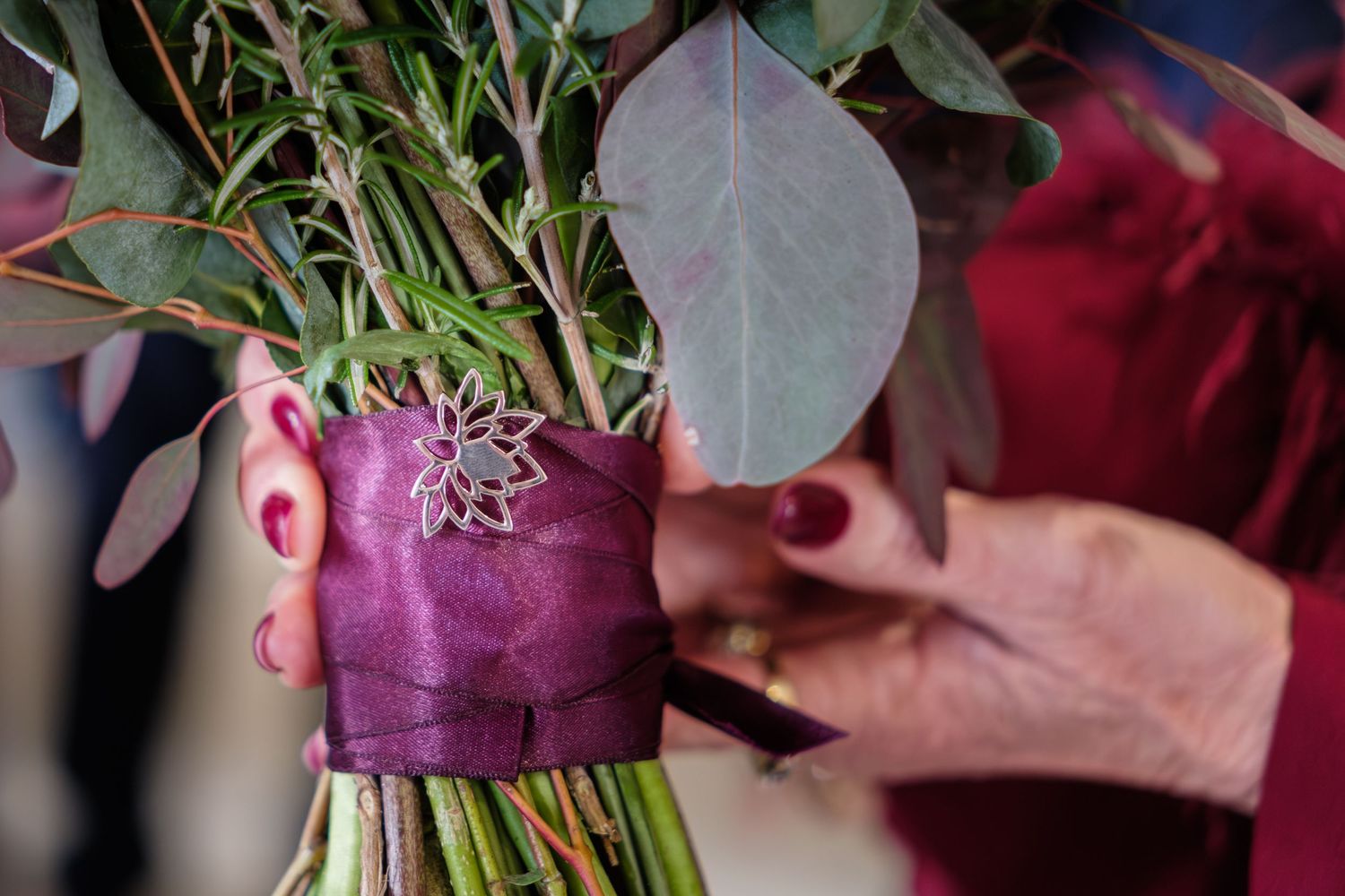 Pink and white floral wedding bouquet with eucalyptus leaves and ribbons.