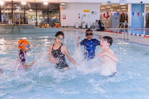 Water polo players competing in an indoor swimming pool during an intense match.