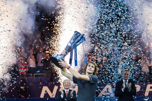 Celebration with blue and white confetti falling during an indoor event.