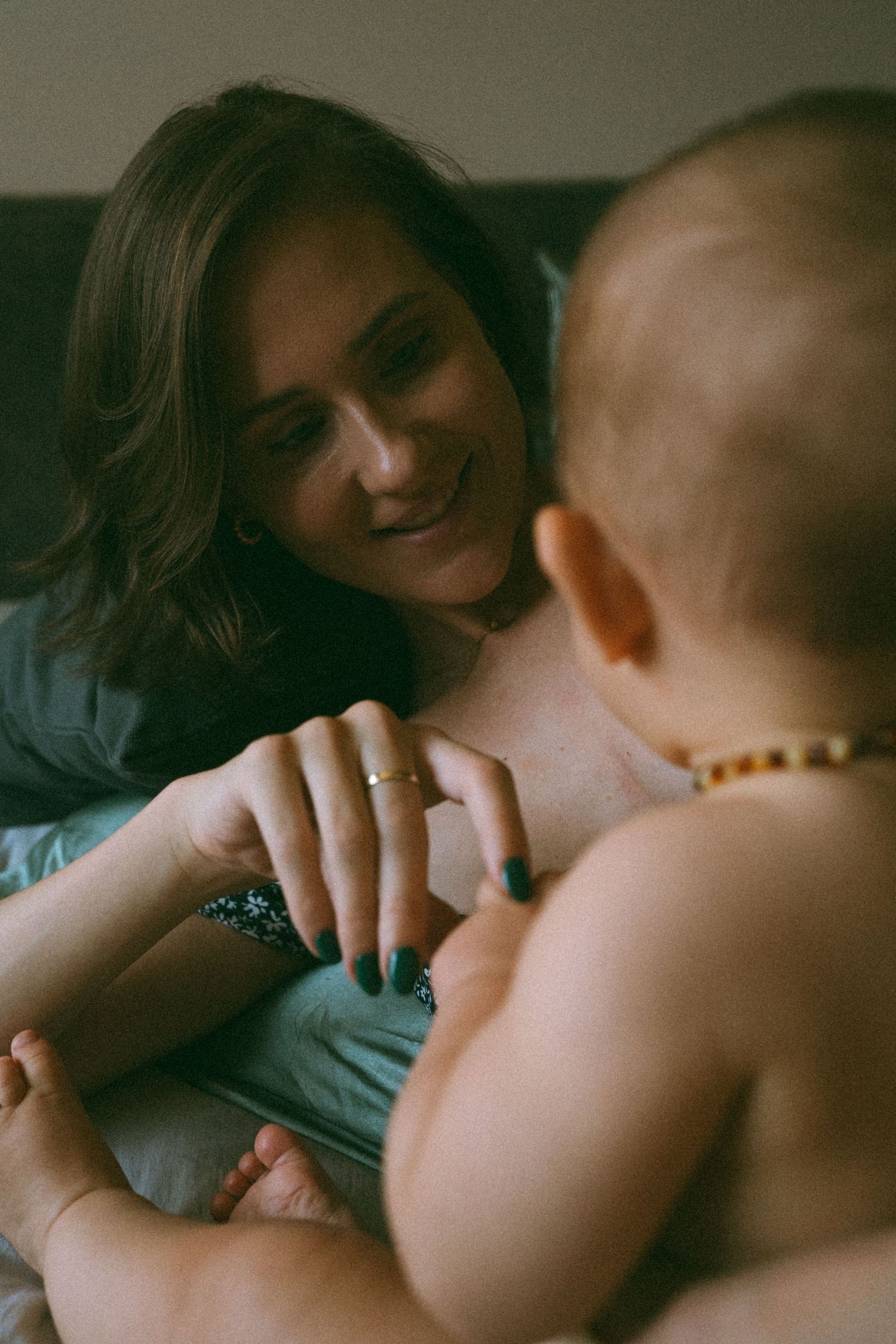 Intimate indoor photography capturing gentle moments in soft lighting with a mother and newborn baby, captured at home in Johannesburg