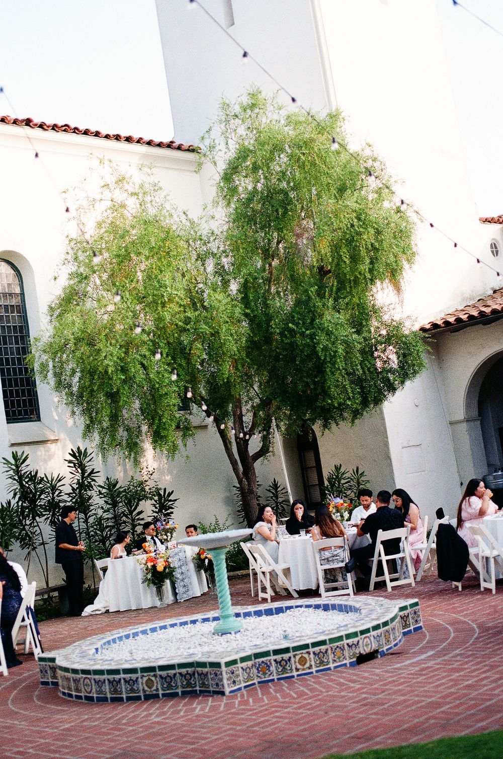 A wide photo of the courtyard reception at Santa Barbara Unitarian Society shot on 35mm film