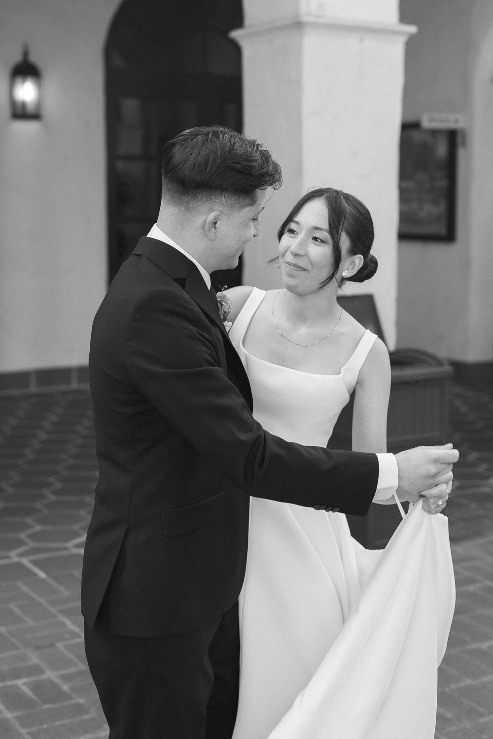 Romantic first dance captured on black and whifilm in the softly lit Unitarian Society courtyard, showcasing the beautiful, soft grain.