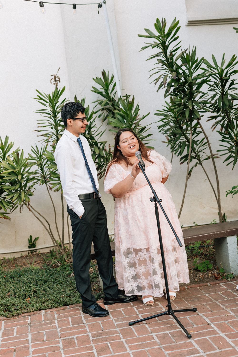 A man and woman give an open-mic toast at a Santa Barbara Unitarian Society wedding.