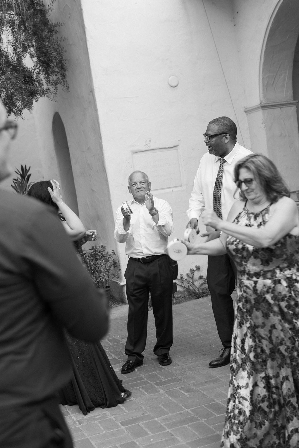 Black and white film photograph showing the wide crowd of guests having fun during the historic Unitarian Society wedding.