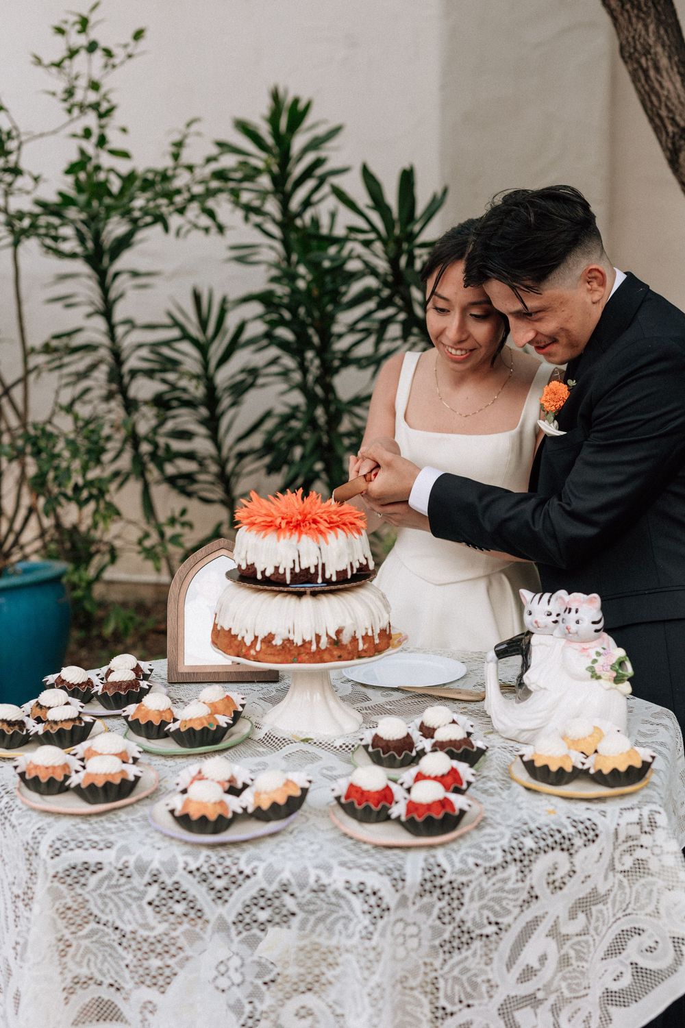 A clear, detailed digital photo of the happy couple performing the cake cutting tradition at their non-traditional Santa Barbara wedding.