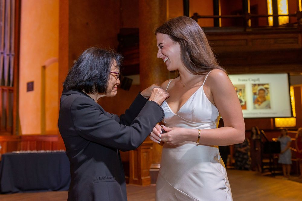 Couples dancing together at an elegant indoor venue with ambient lighting.