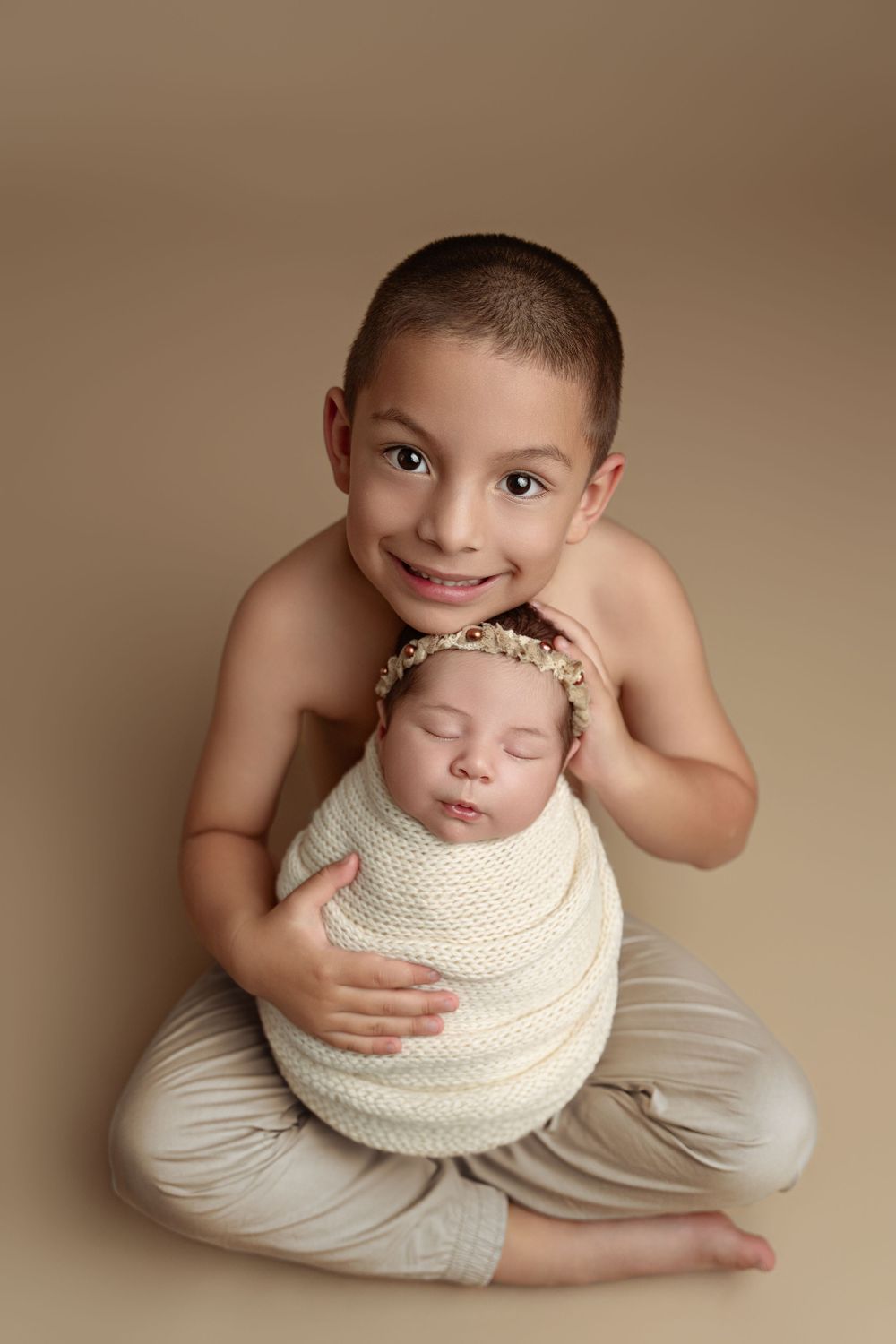 Artistic newborn photography sequence showing infant wrapped in cream knit blanket against neutral beige backdrop. Paloma Schell