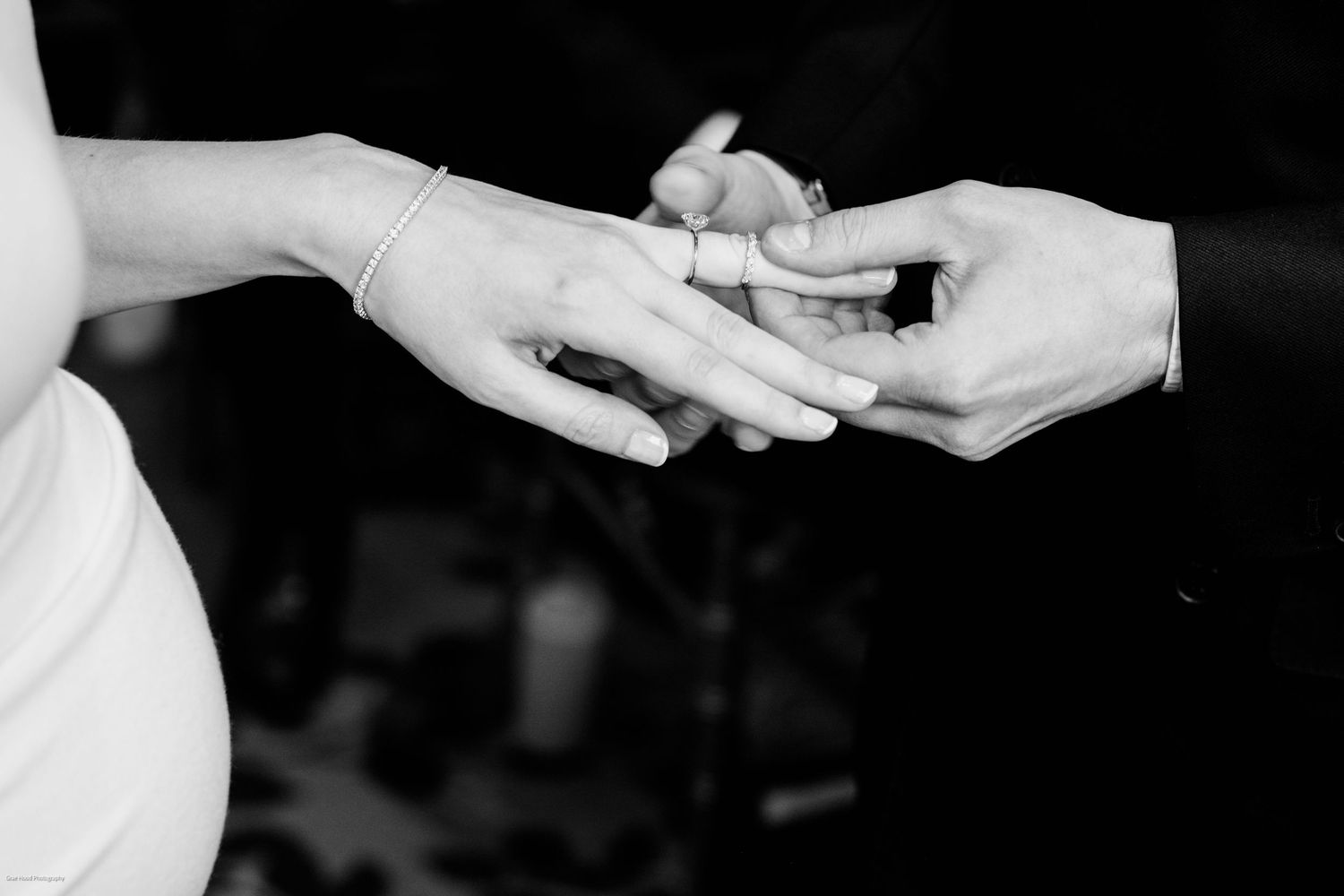 A couple shares an intimate dance moment during their wedding reception in a warmly lit venue.
