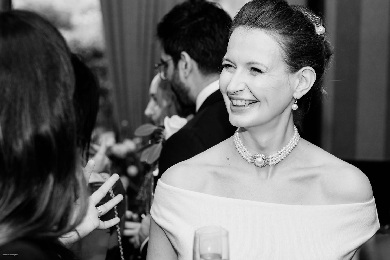 A series of black and white candid photos showing joyful expressions and laughter at a formal event.