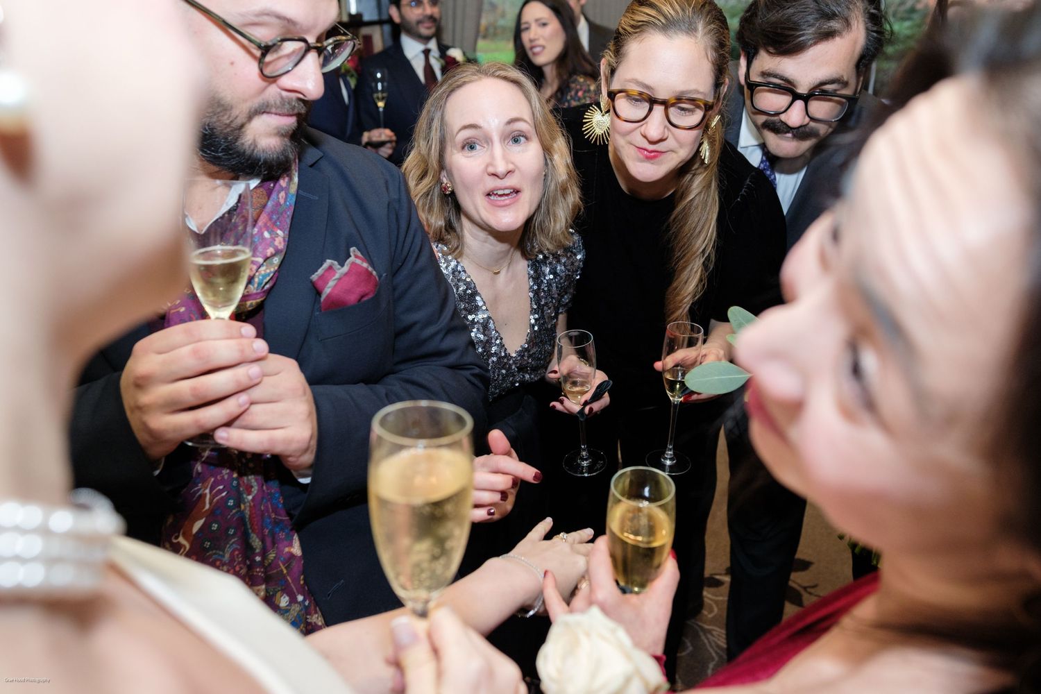 People enjoying drinks and conversation at a lively social gathering or party.
