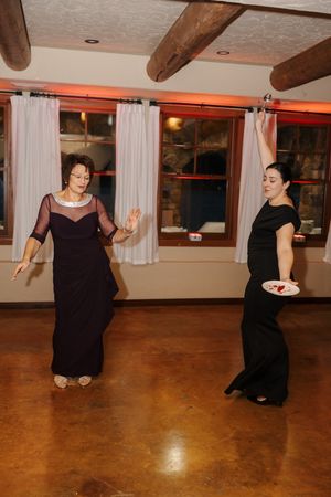 A sequence of dance movements captured across multiple frames showing a person in black attire on a wooden floor.