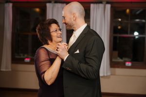 A couple shares a romantic dance together at an evening reception venue.