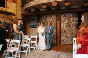 A collage of wedding ceremony photos showing guests seated in white chairs inside a rustic stone-walled venue.