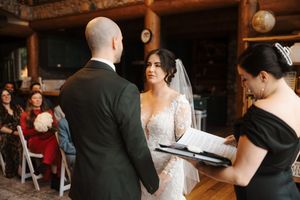 A couple dances together during a wedding reception in an elegant indoor venue.