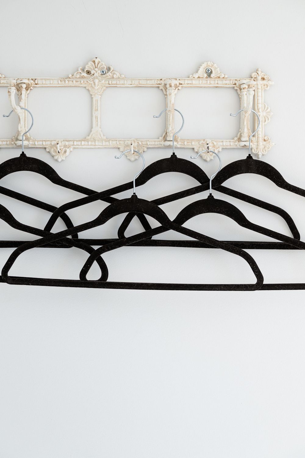 Decorative ornate white plaster molding and black ribbon design elements against a light background.