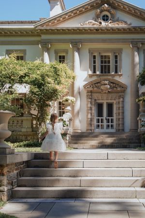 Classic architecture of a grand white building with columns and ornate details.
