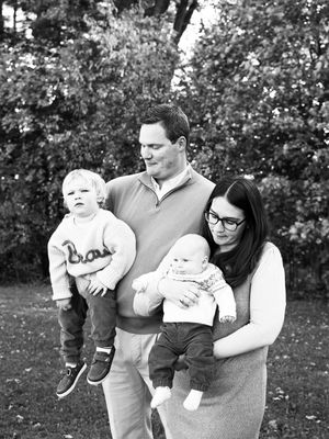 A black and white photo series showing a family outdoors in a park setting with trees in the background.