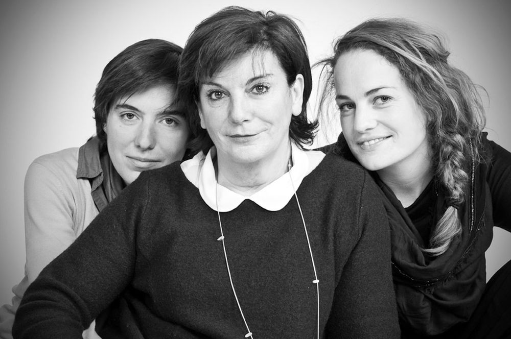Black and white studio portraits showing casual group poses with dramatic lighting.