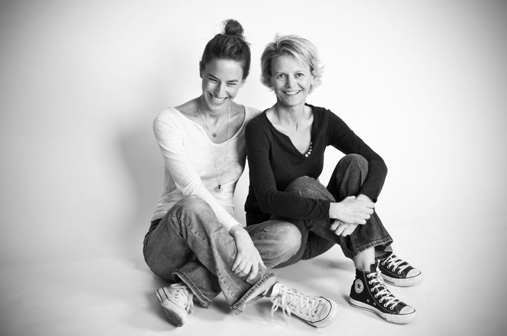 Black and white photo series capturing candid moments between two people wearing casual dark clothing.