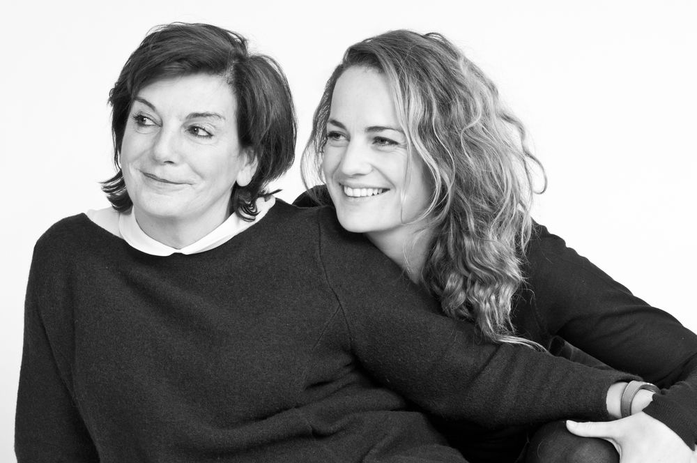 Portrait series showing relaxed interactions between two subjects in black clothing against white backdrop.