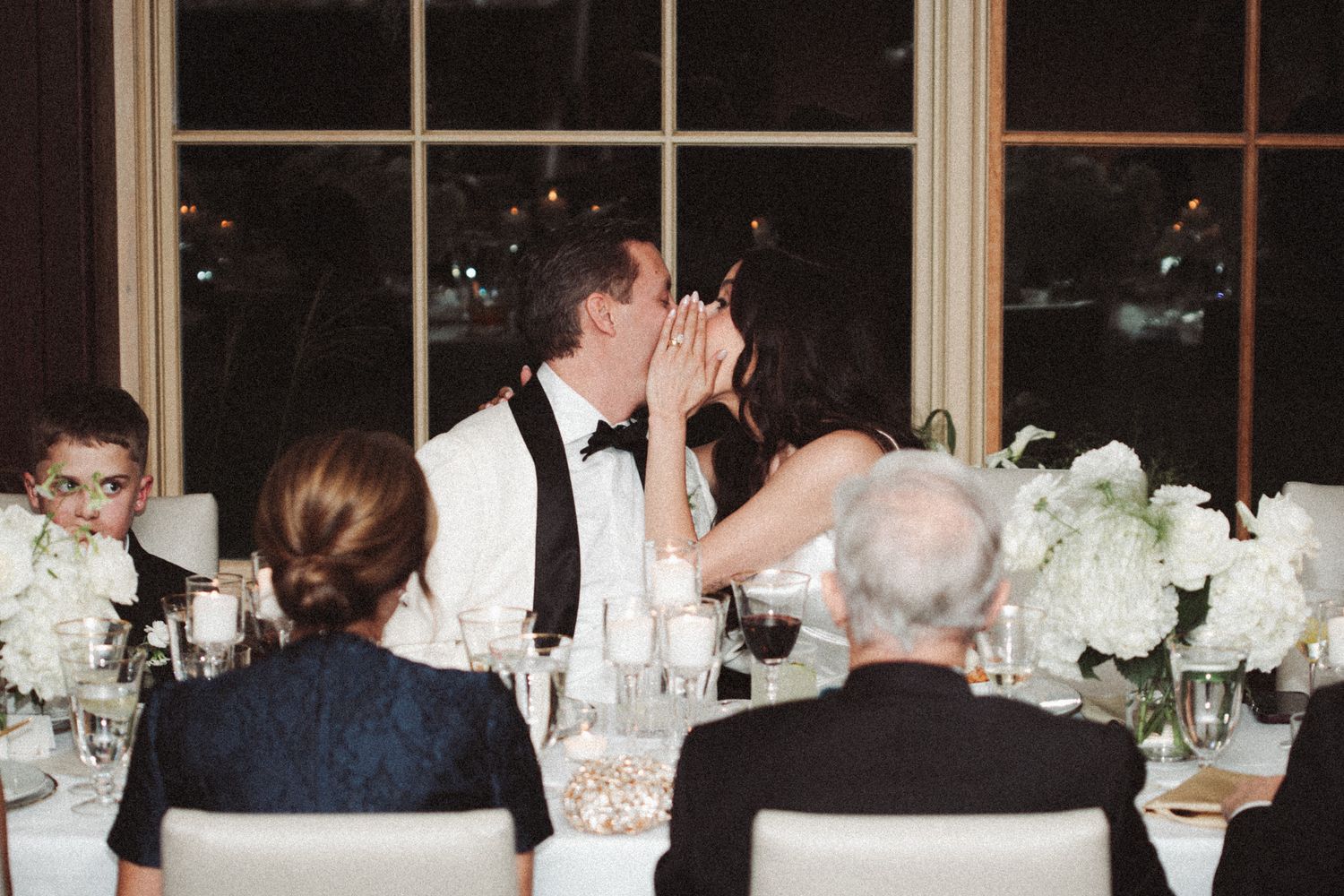 Couple dancing together at night surrounded by sparklers creating a romantic outdoor celebration atmosphere.