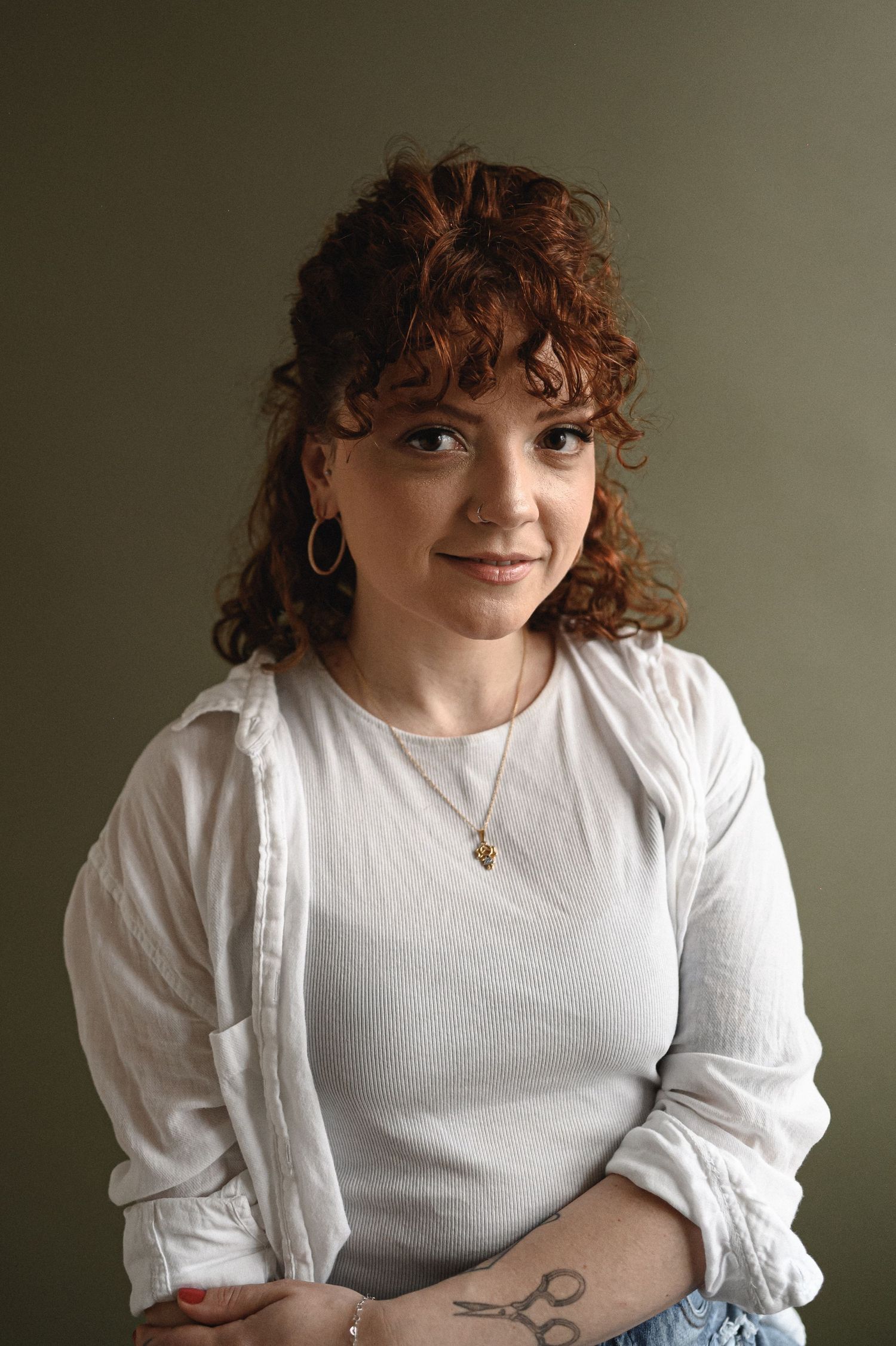 Portrait series featuring person in white puff sleeve top with tattoo.