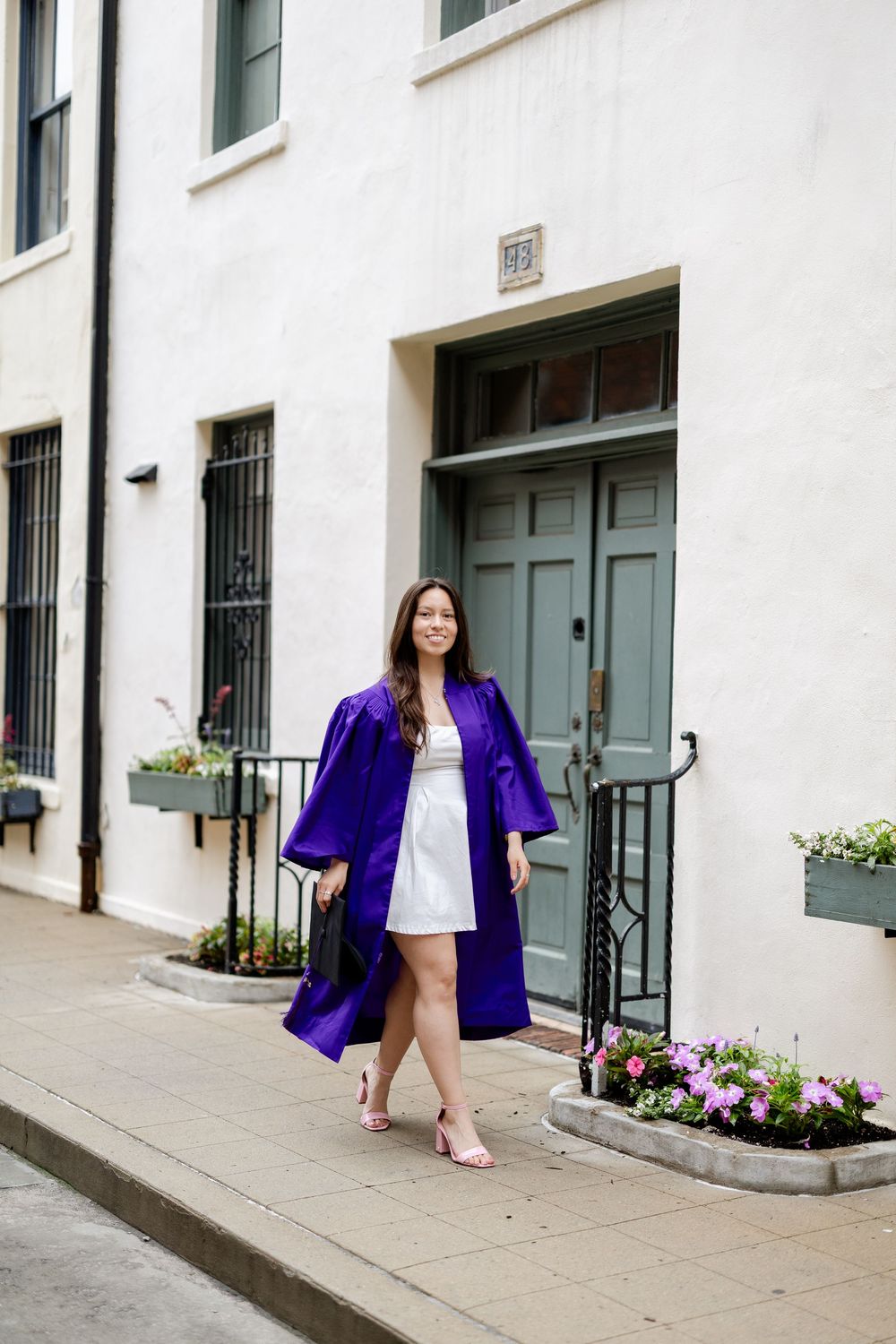 A series of fashion photos showing a bright purple blazer and white dress against a residential building entrance.