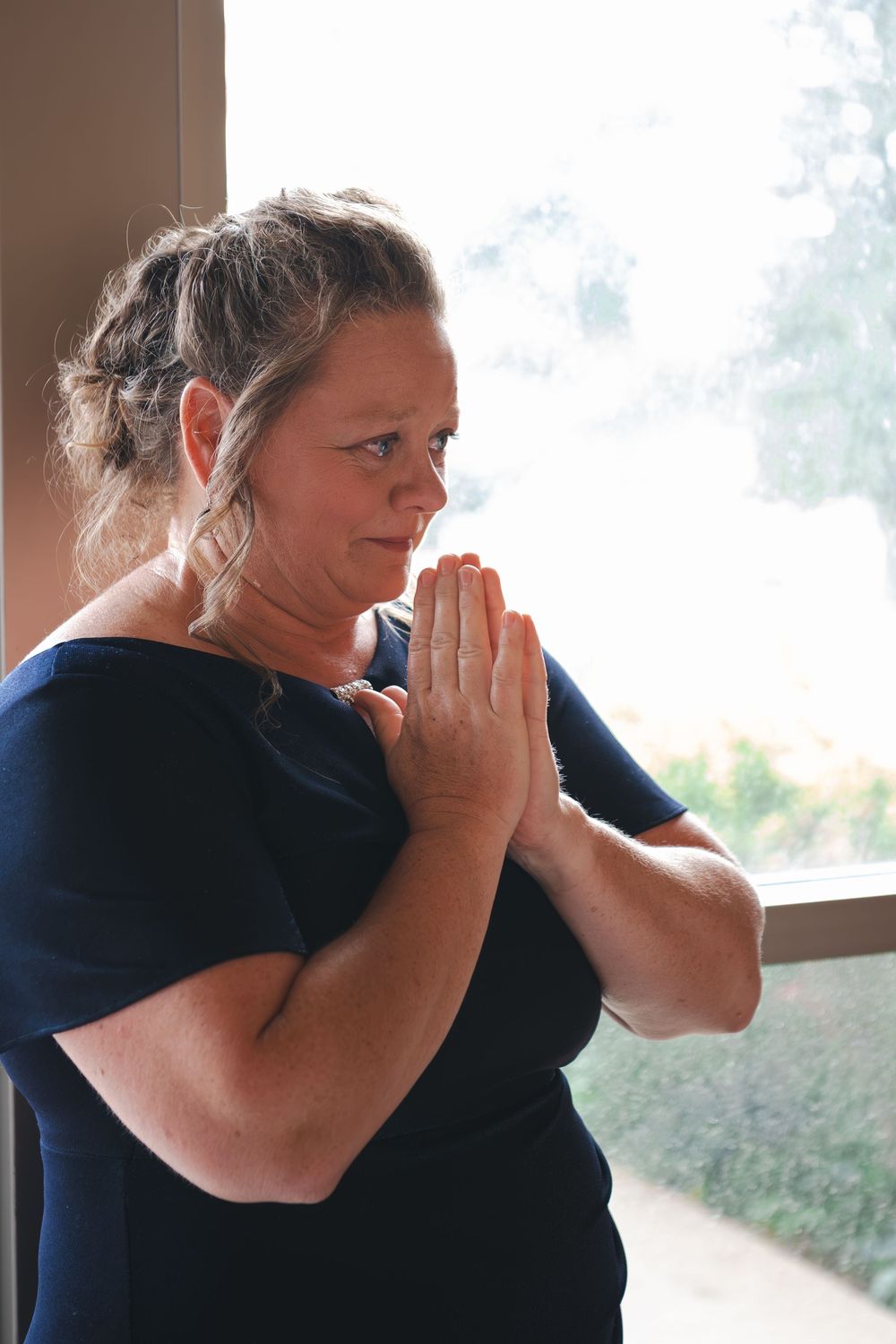 An emotional moment captured by a window in natural lighting.