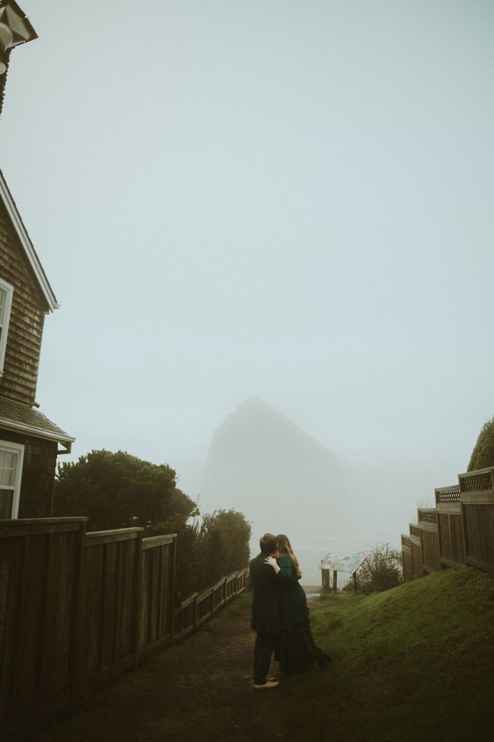 A series of four misty photos showing someone walking up steep wooden stairs on a foggy hillside.