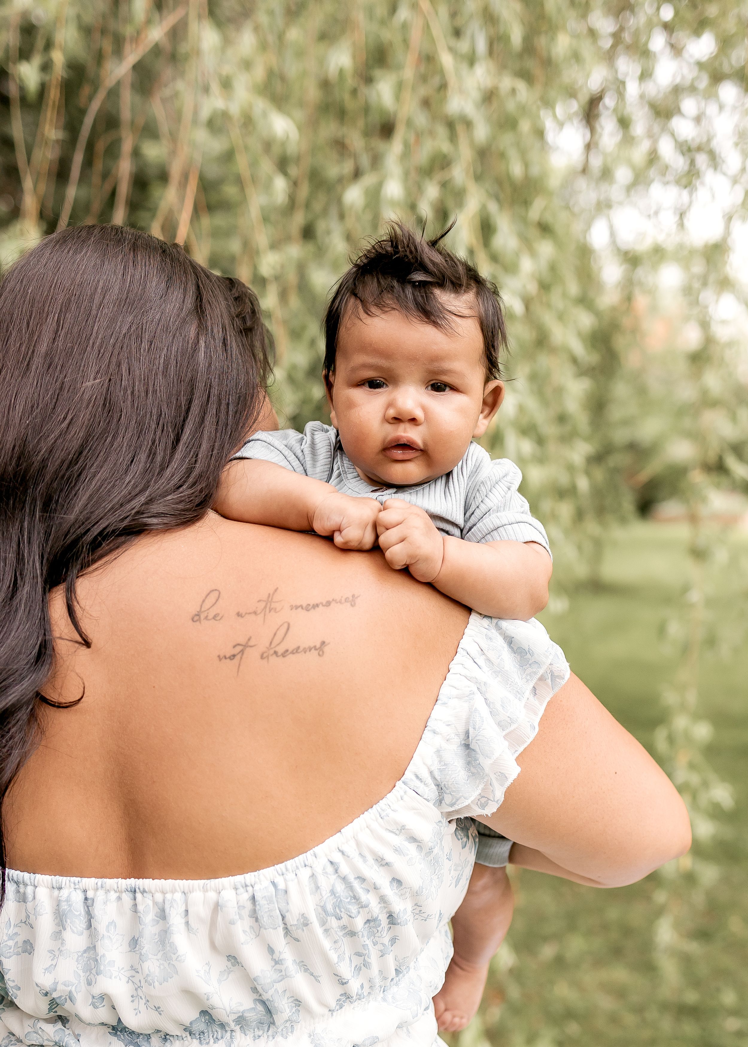 Close-up series showing a small baby peeking over someone's shoulder with a tattoo visible.
