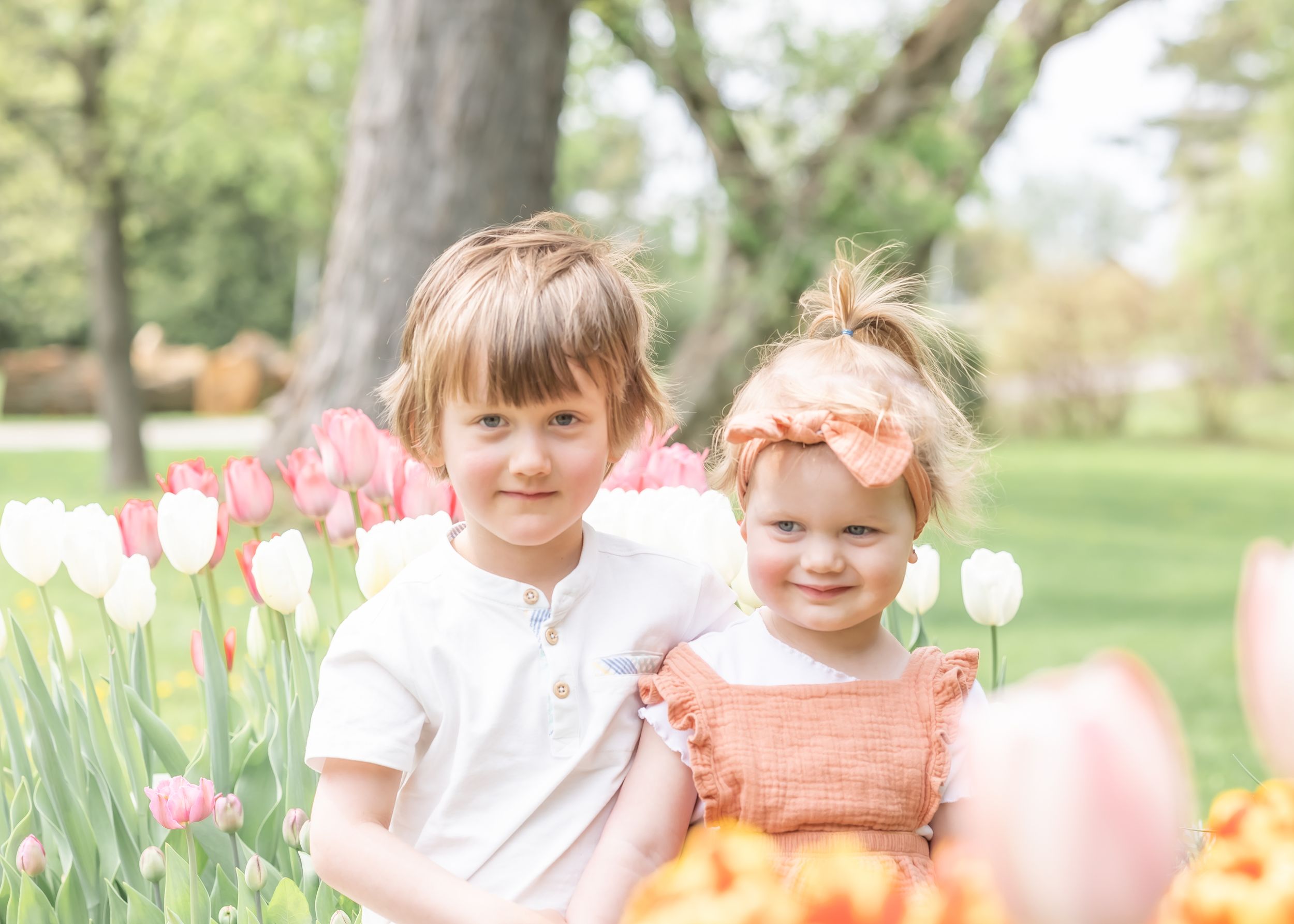 Siblings sitting in the tulips during a spring photo session
