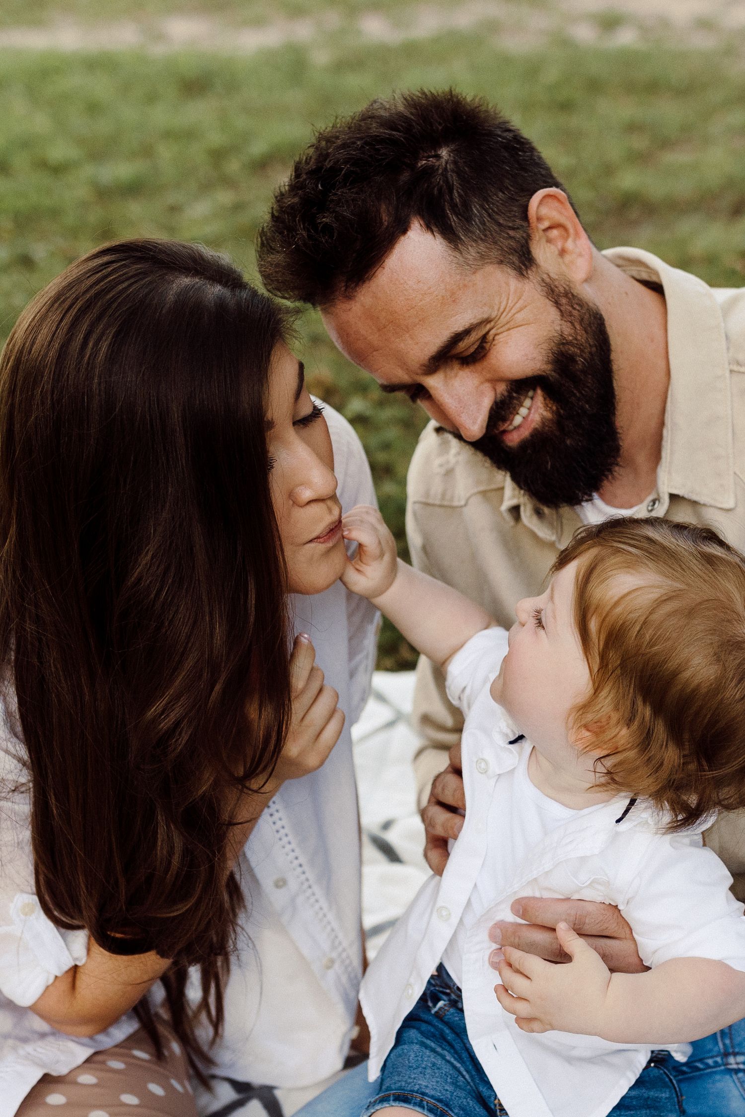 Intimate family photos showing tender moments in a garden setting.