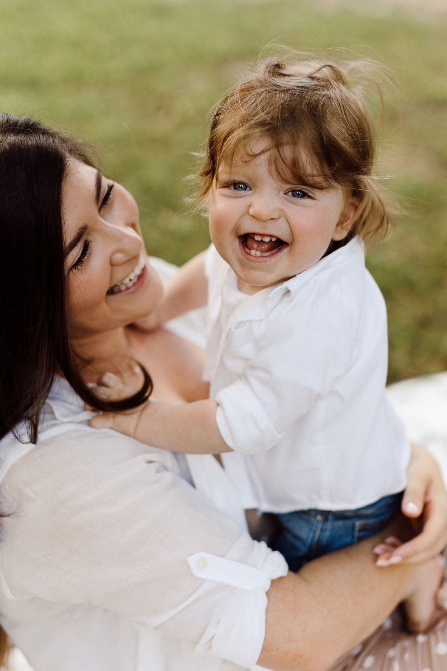 Playful outdoor photoshoot showing joyful family interactions and laughter.