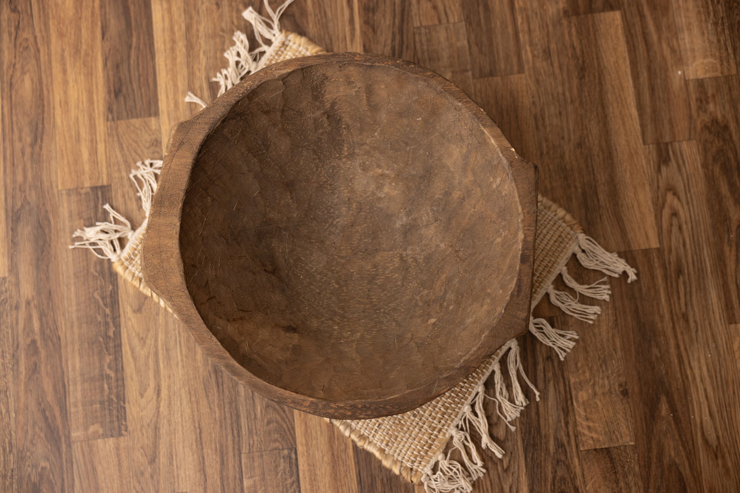 Dark round wooden bowl with flat small handles