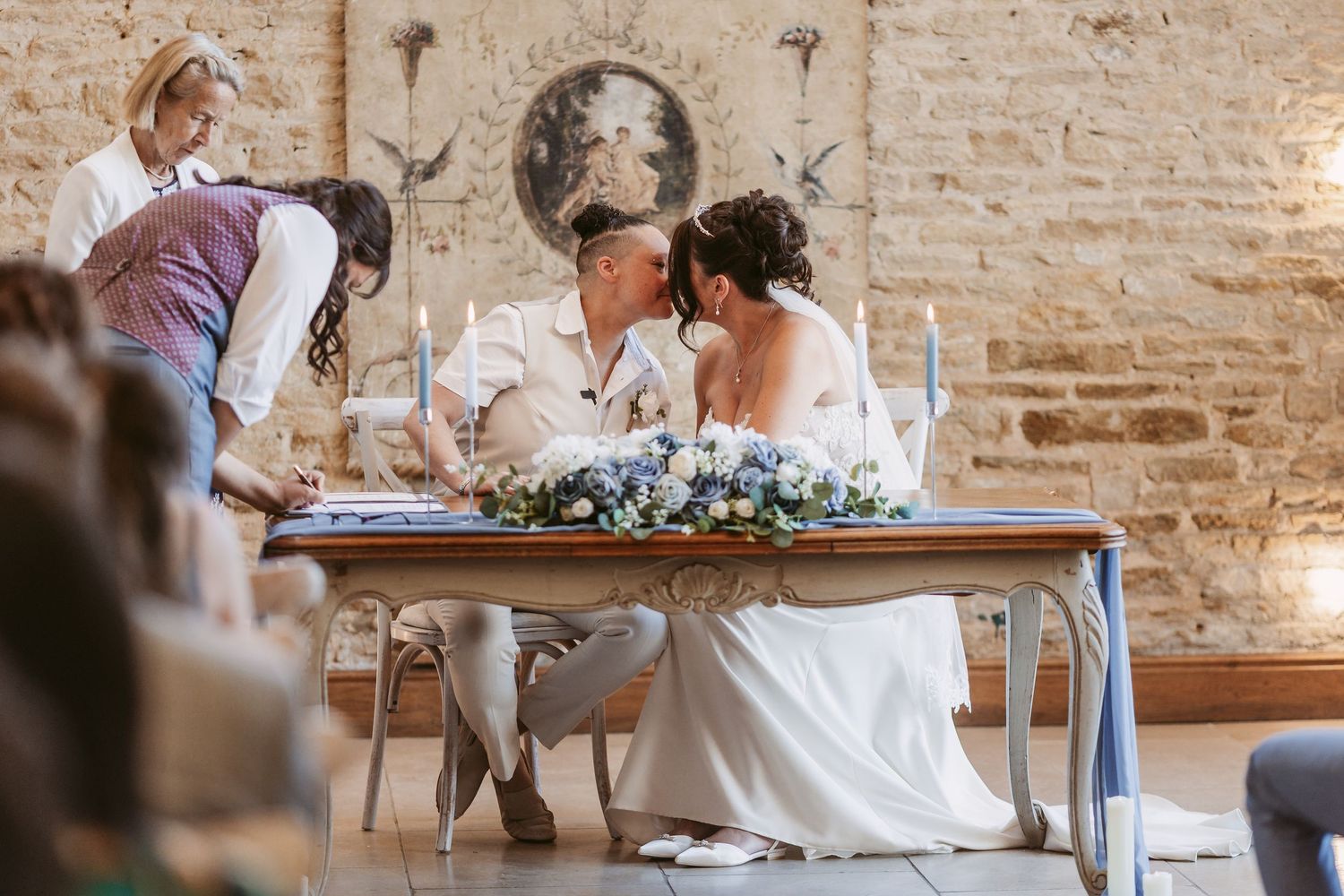 Wedding celebration in elegant rustic venue with exposed brick walls and hanging string lights.