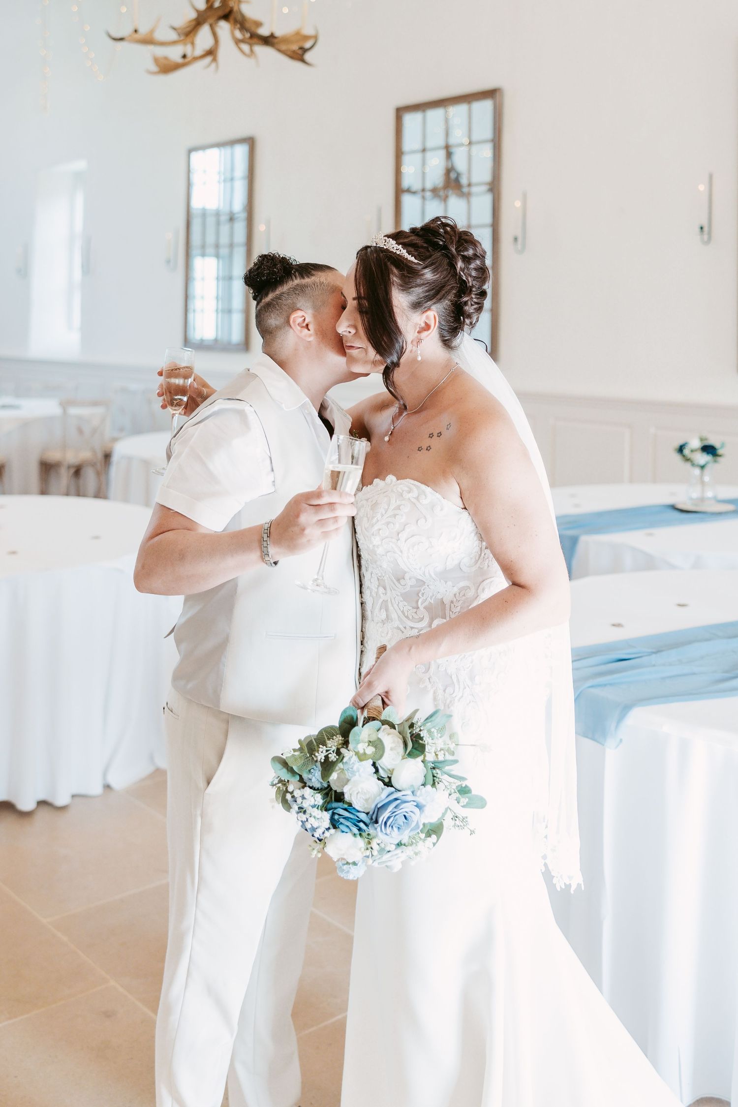 Romantic first dance moments in an elegant white reception hall.