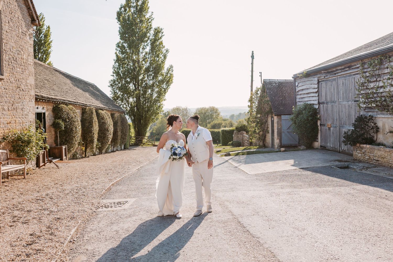 A series of wedding photos showing a couple walking on a rustic stone path surrounded by greenery.