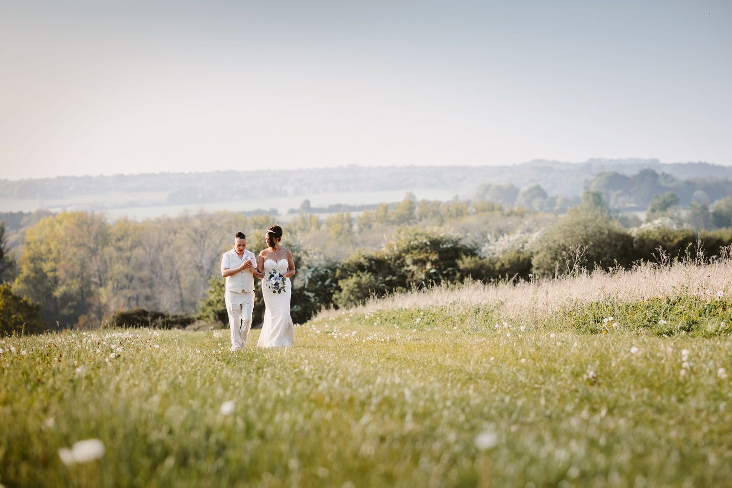 Rolling countryside hills create scenic backdrop for wedding photography.