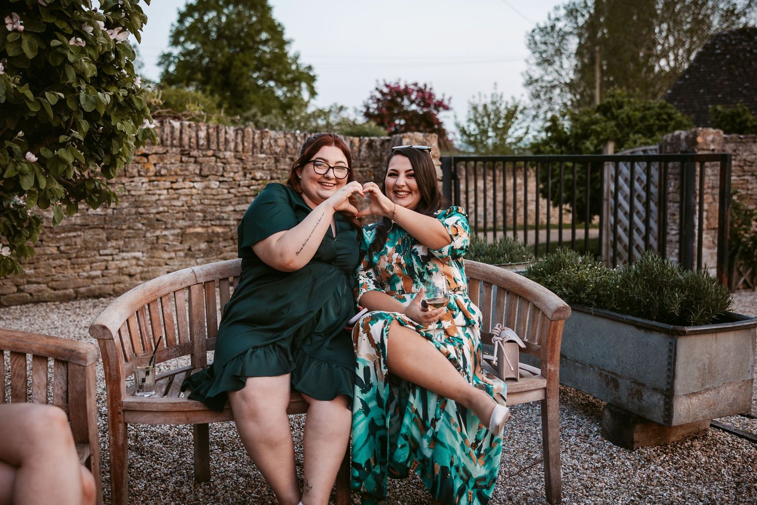 A couple shares a joyful moment together on outdoor garden furniture.