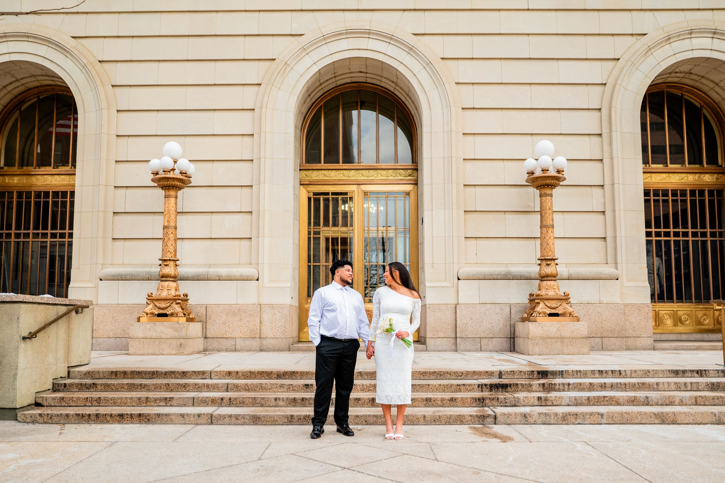 Classic architectural wedding venue with elegant arched windows and stone columns.