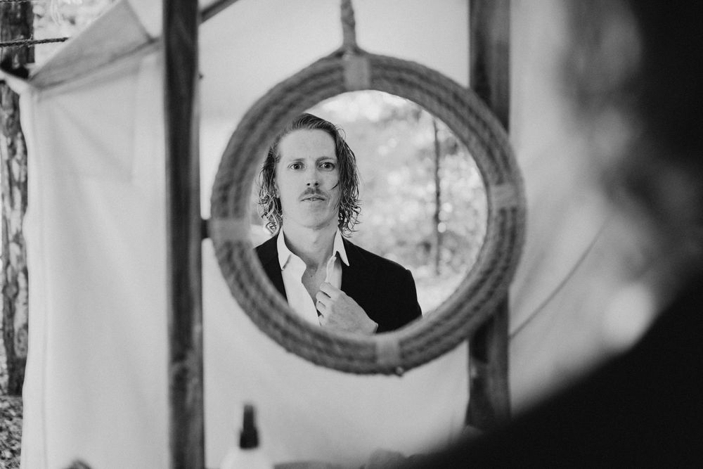 Vintage-style black and white portraits displayed in ornate oval frames on a wall.