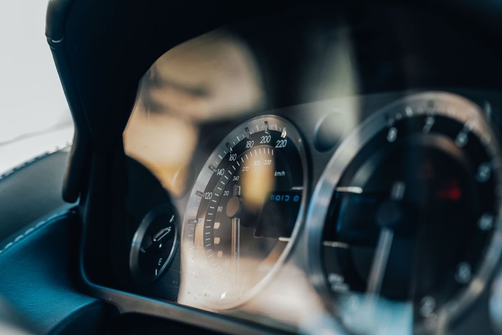 A series of dark interior car photos showing dashboard instruments and controls in low light conditions.