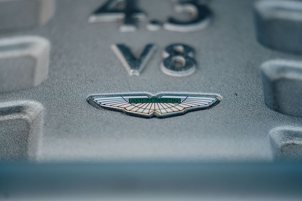 Macro shot of Aston Martin V8 engine badge details.