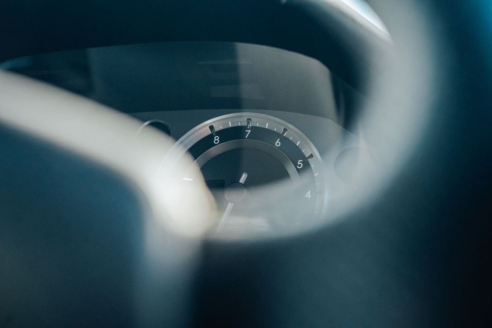 Artistic shallow depth of field shot of luxury vehicle dashboard gauges.