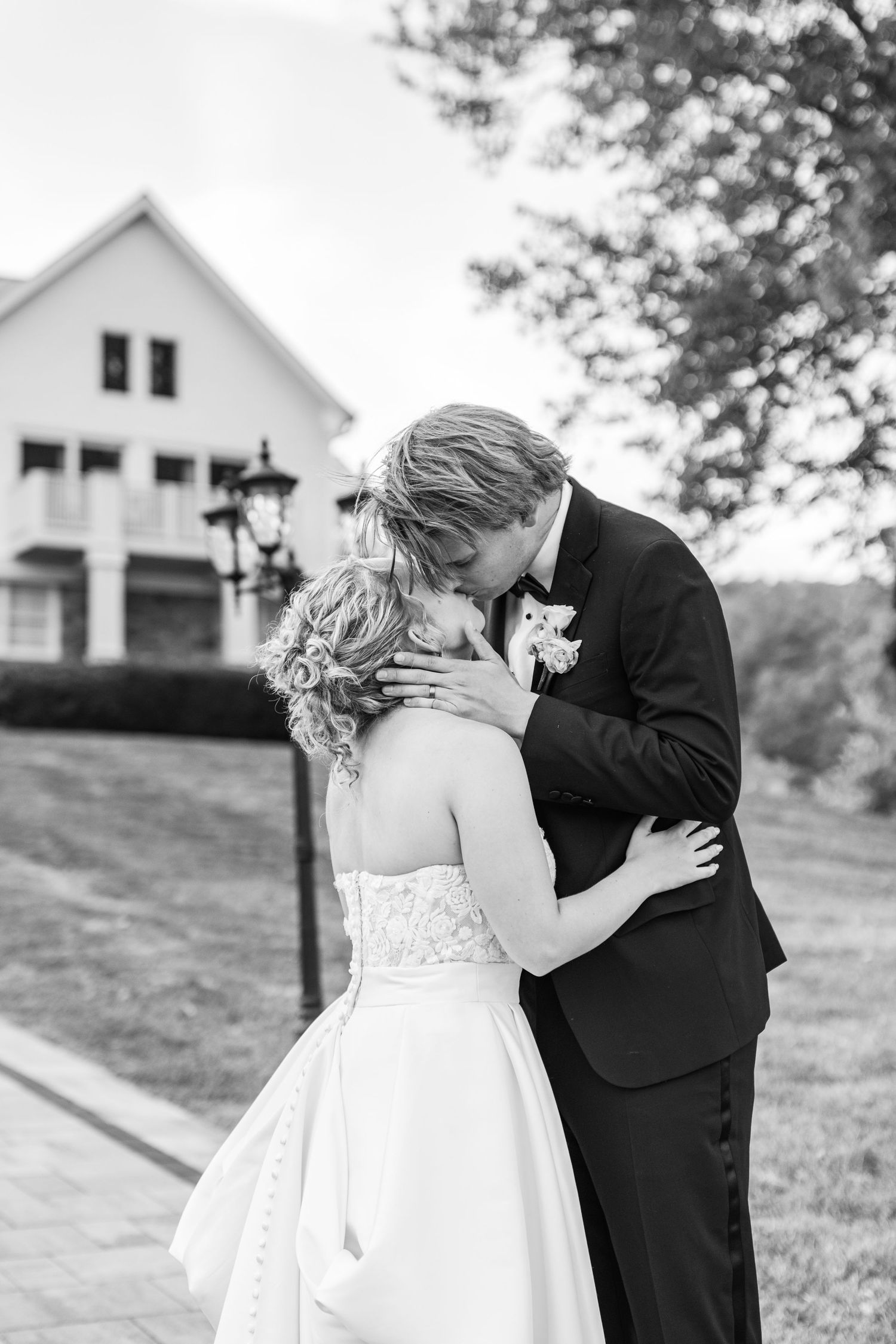 Black and white romantic wedding portrait in front of historic building.