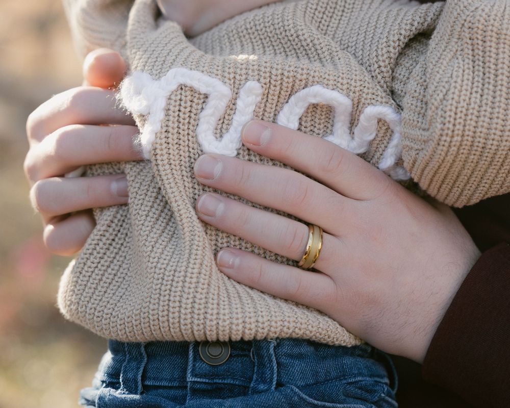A series of cropped photos showing hands wearing knit sweaters and jeans in warm natural lighting.