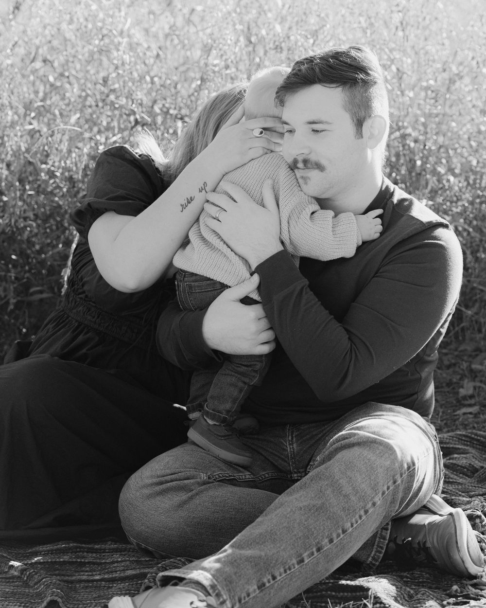 Black and white series of intimate couple portraits captured in a natural outdoor setting.